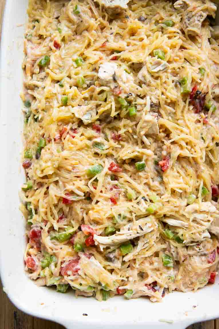 Cheesy Chicken Spaghetti Squash Casserole ingredients mixed in a casserole dish.
