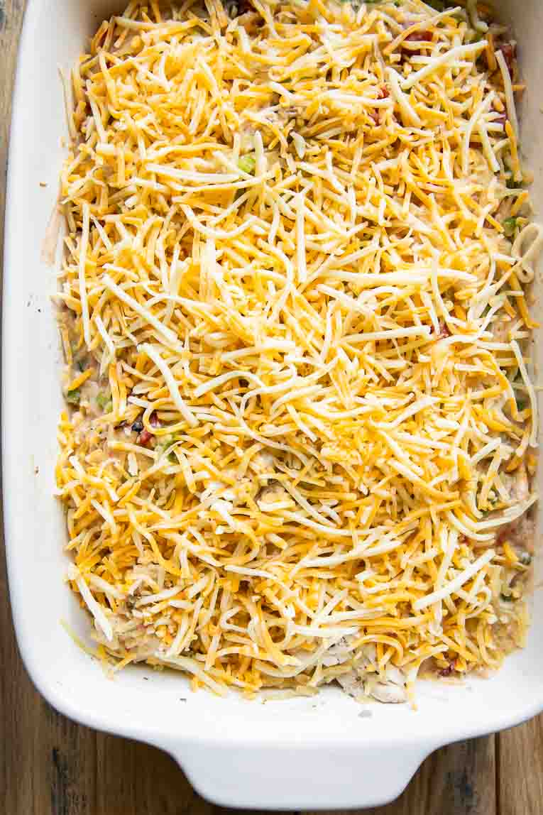 Cheesy Chicken Spaghetti Squash Casserole topped with cheese before baking.