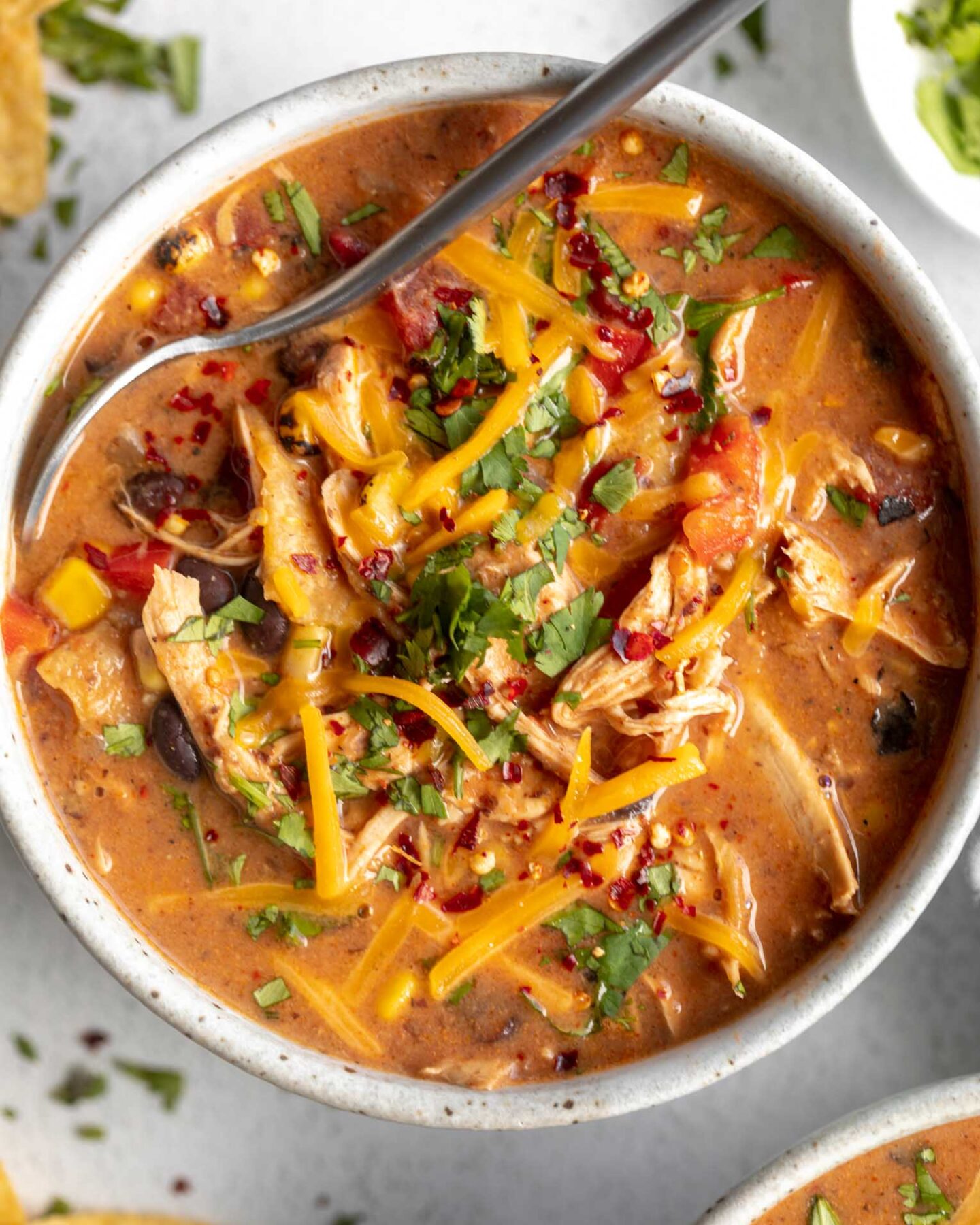 Chicken Taco Soup recipe in a large bowl with a spoon.