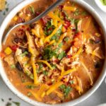 Chicken Taco Soup recipe in a large bowl with a spoon.