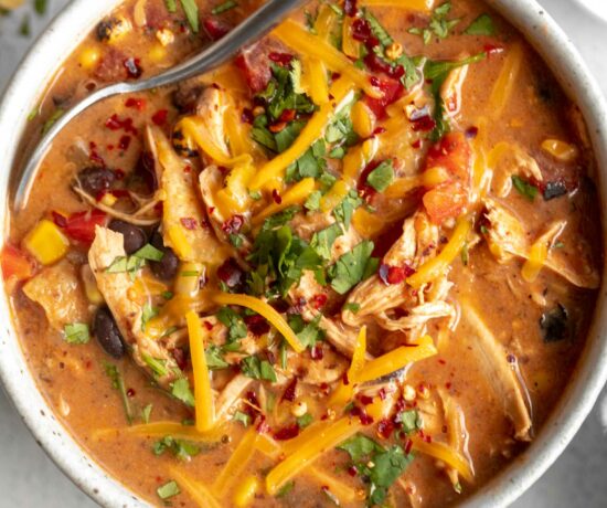 Chicken Taco Soup recipe in a large bowl with a spoon.