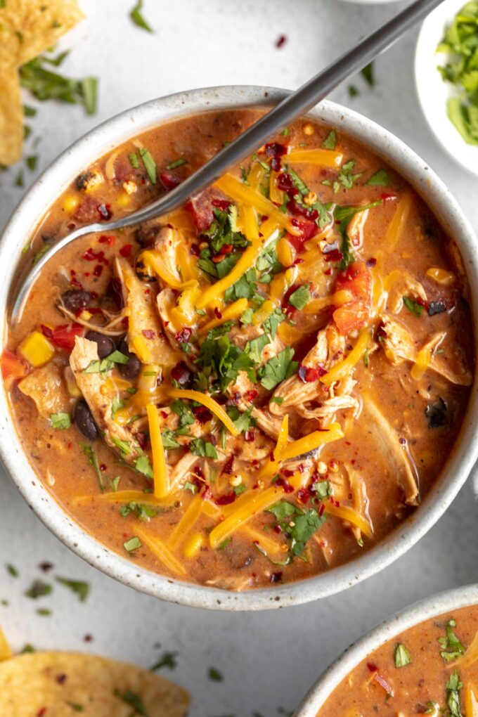 Chicken Taco Soup recipe in a large bowl with a spoon.