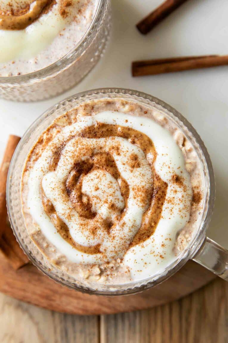 Close up top shot photo of Cinnamon Roll Overnight Oats in mug.