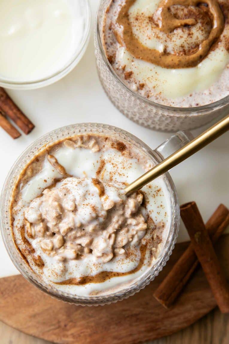 Spoon eating Cinnamon Roll Overnight Oats.