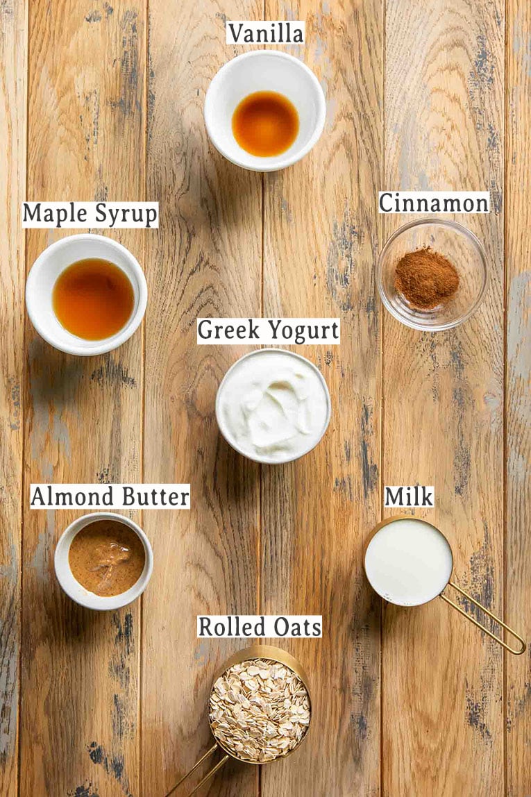Ingredients for Cinnamon Roll Overnight Oats recipe on a wood table.
