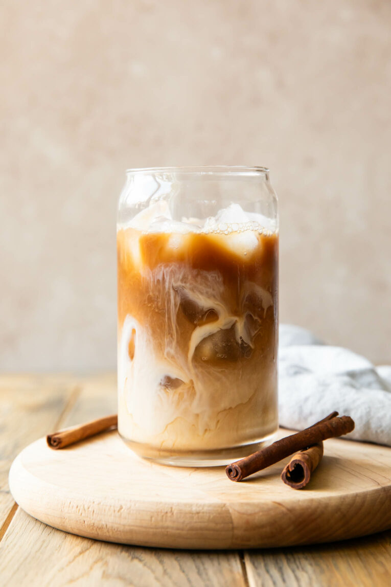 Swirled Iced Apple Crisp Cream Chai recipe in a glass.