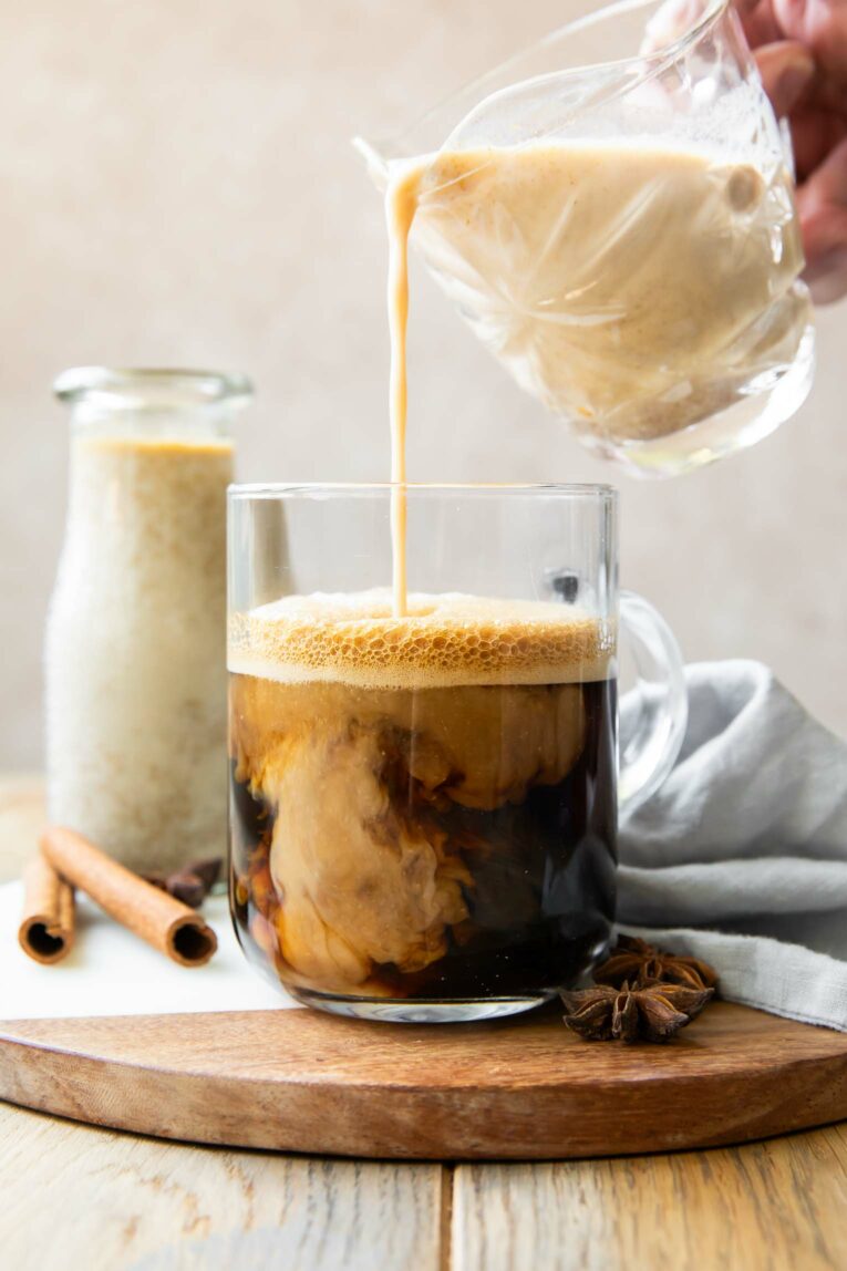 Vegan Pumpkin Creamer being poured into coffee.