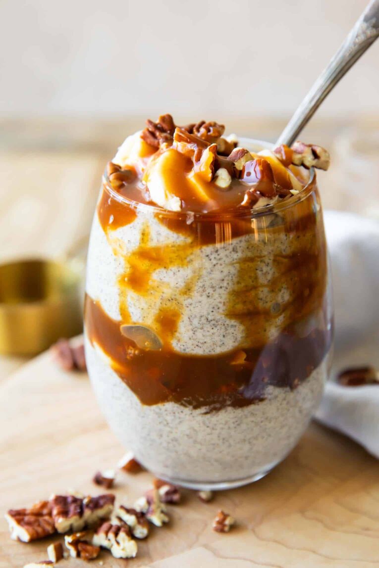 Close up angled photo of chia seed parfait with caramel and bananas.
