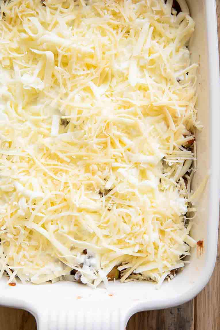 Cottage cheese and healthy sauce over noodles for lasagna.