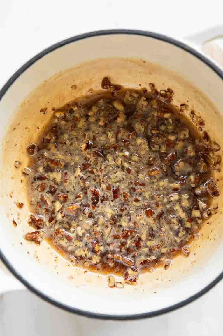 Pecans chopped and cooking in maple syrup.