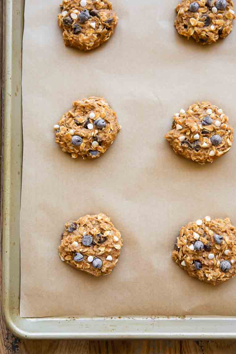 Top shot photo of Pumpkin Oatmeal Cookie dough balls on a baking sheet.
