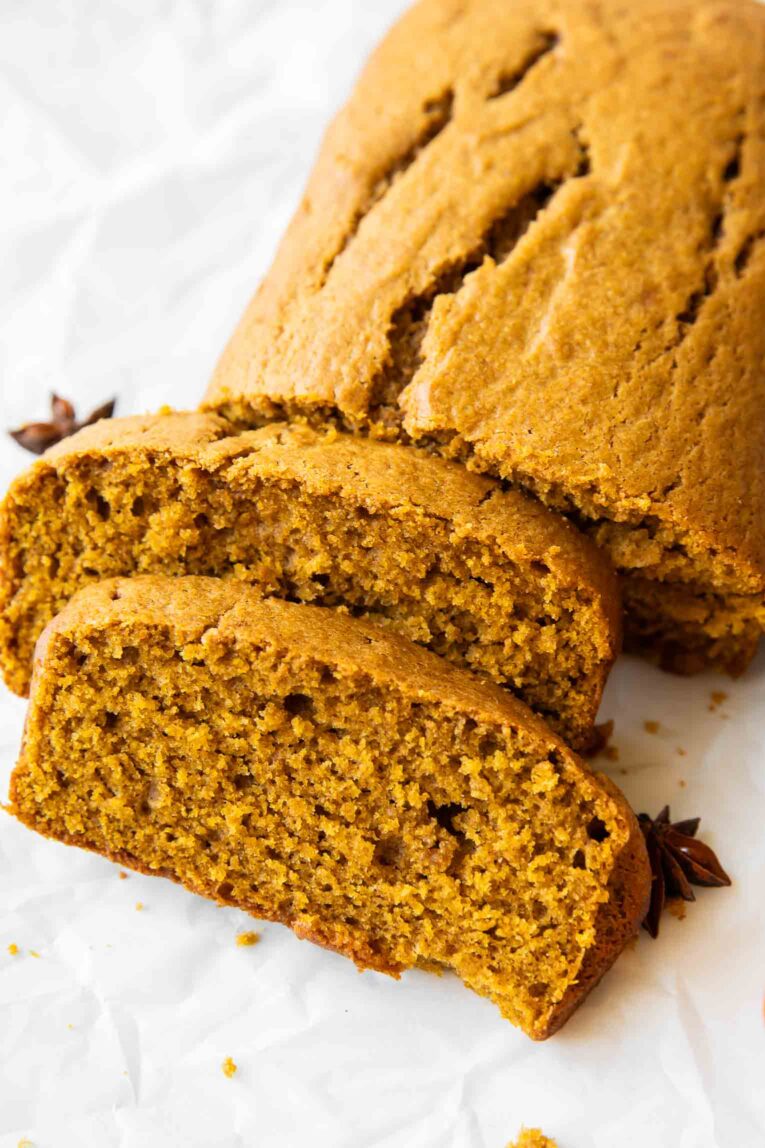 Angled photo of slices of pumpkin loaf cake.