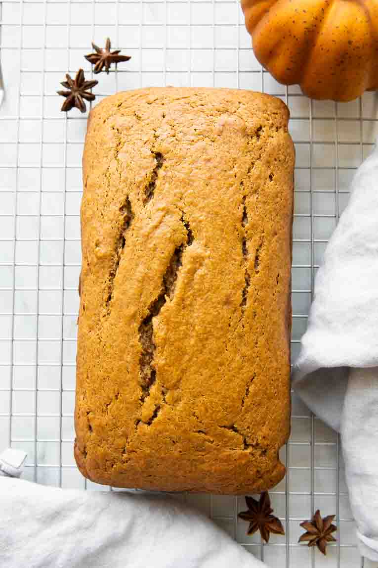 Freshly baked pumpkin cake on a cooling rack.