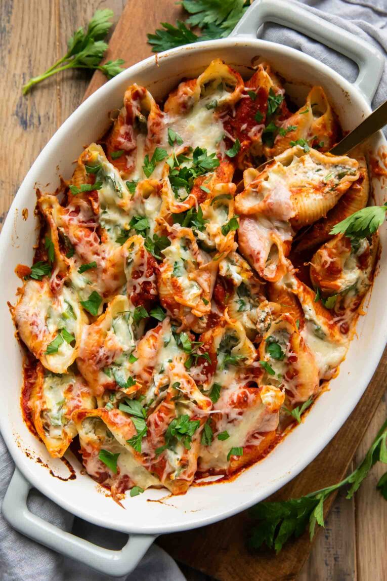 Chicken Spinach Artichoke Stuffed Shells recipe in a casserole dish.