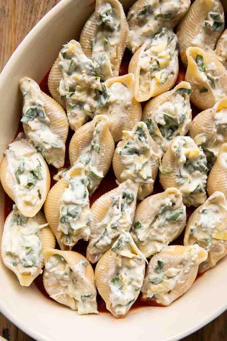 Chicken stuffed shells in a baking dish.