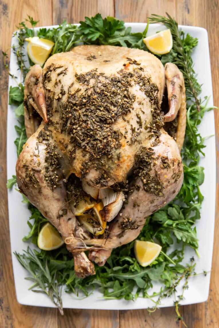 Thanksgiving turkey on a serving dish with greens.