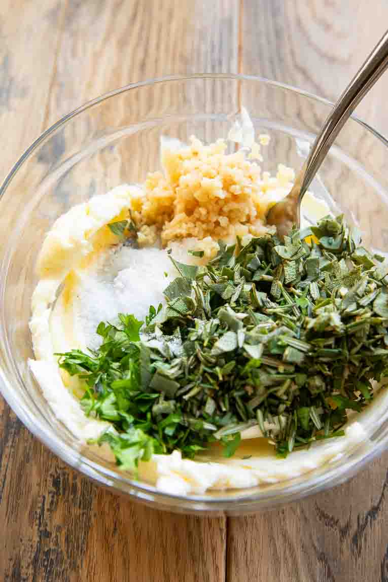 Ingredients for herb butter in a mixing bowl.
