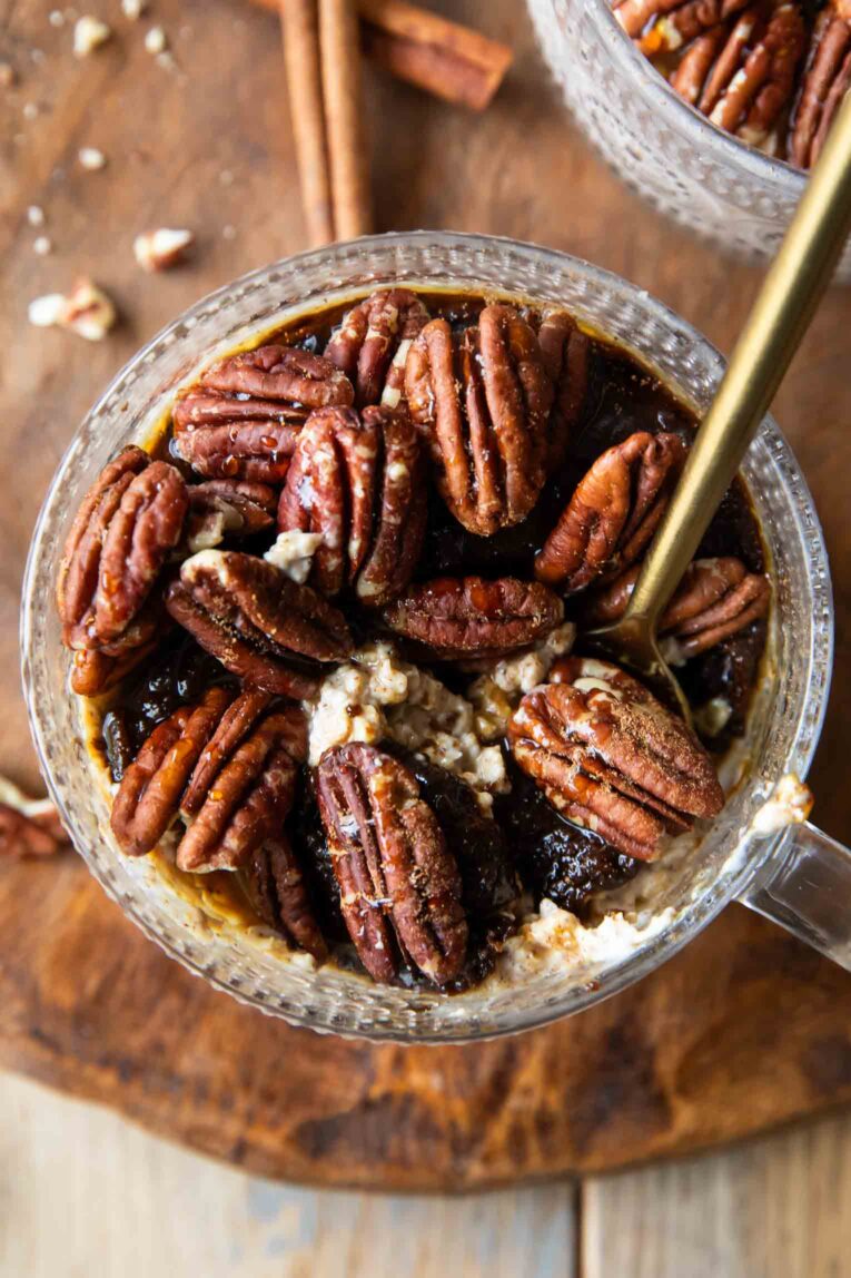 Top shot photo of Maple Cinnamon Pecan Overnight Oats in a jar with a spoon.