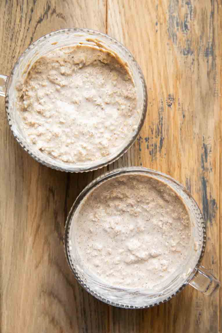 Maple overnight oats in jars on a table.