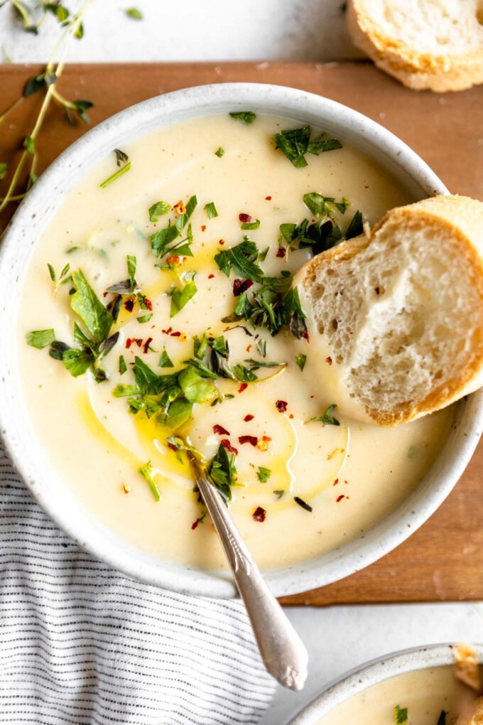 Top shot photo of Potato Leek Soup with garnish and bread.