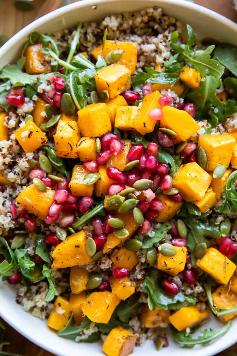 Close up of garlic quinoa with roasted butternut squash in a bowl.