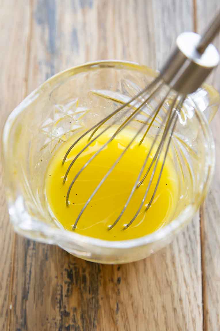 Lemon dressing being whisked.