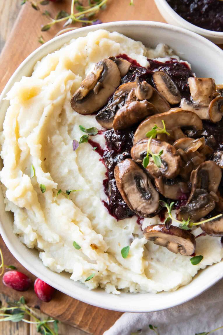 Close up of Crockpot mashed potatoes in a bowl with mushrooms.