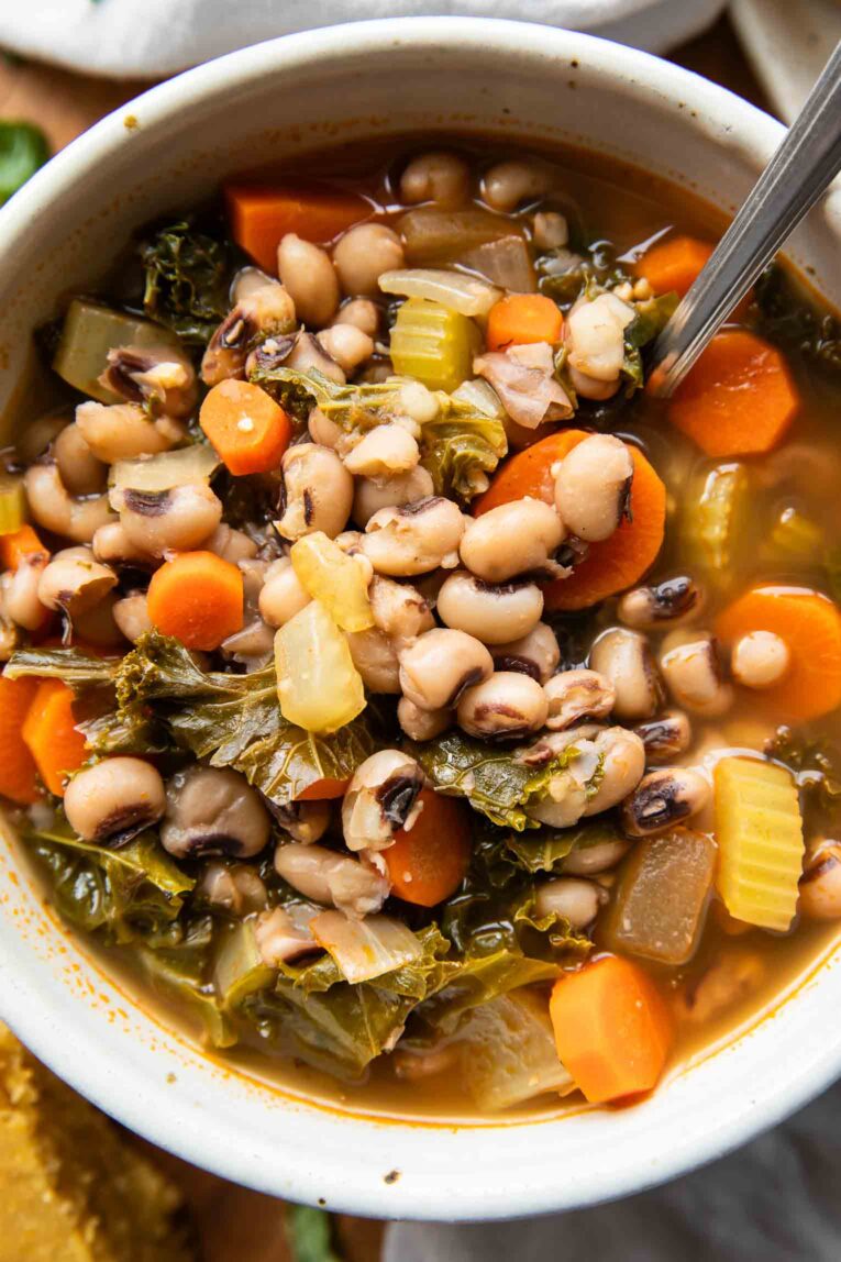 Close up of Black Eyed Pea Soup recipe in a bowl with a spoon.