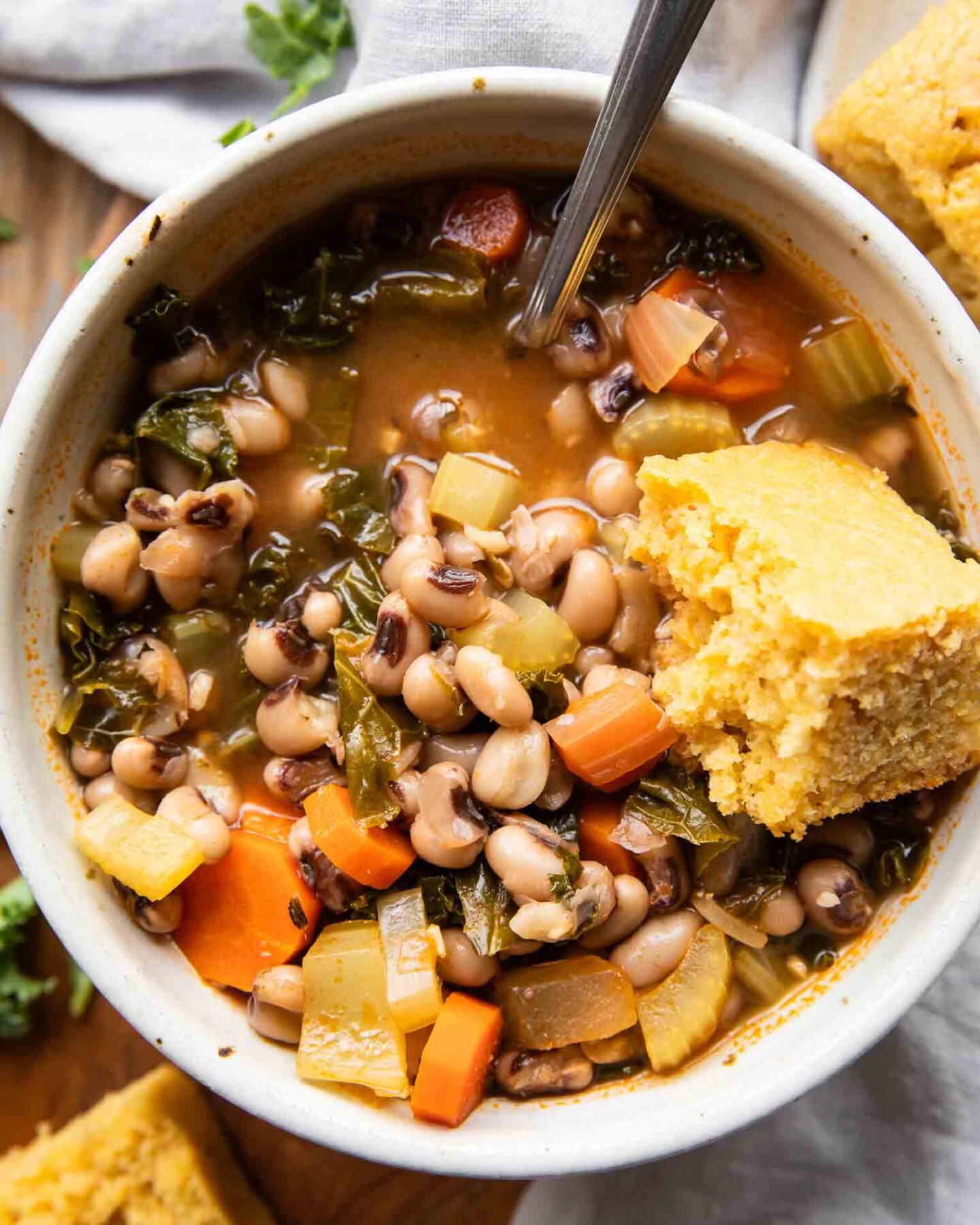 Close up of Black Eyed Pea Soup in a bowl with cornbread.