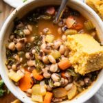 Close up of Black Eyed Pea Soup in a bowl with cornbread.