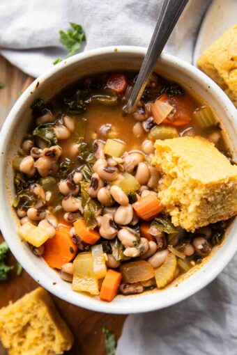 Close up of Black Eyed Pea Soup in a bowl with cornbread.