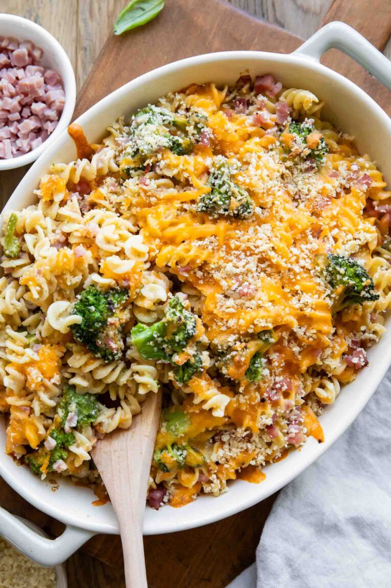 Broccoli Cheddar Ham Pasta Casserole with a spoonful being taken out.