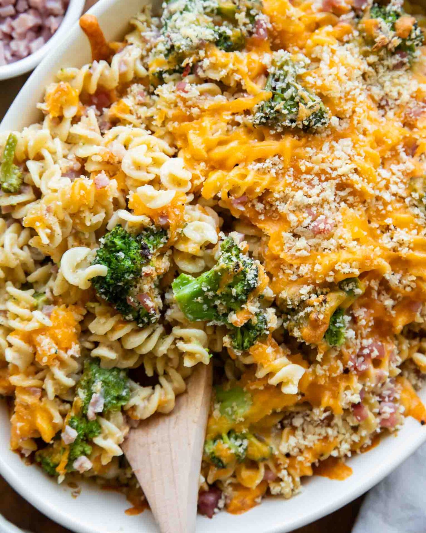 Broccoli cheddar casserole with ham in a dish.