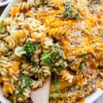 Broccoli cheddar casserole with ham in a dish.