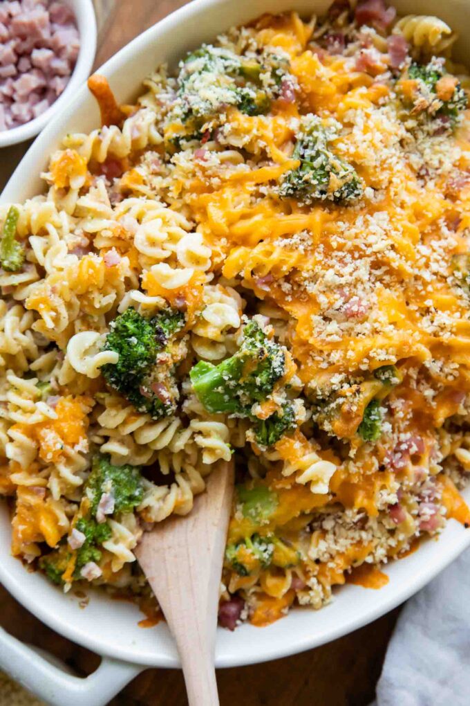 Broccoli cheddar casserole with ham in a dish.