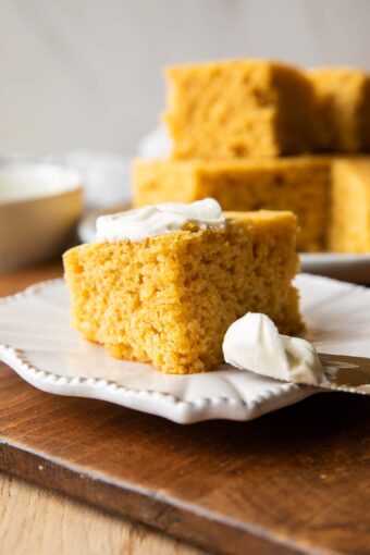 Slice of Cornbread on a plate with butter.