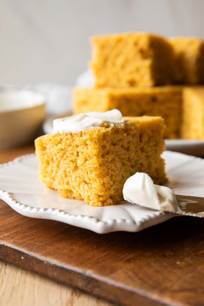 Slice of Cornbread on a plate with butter.