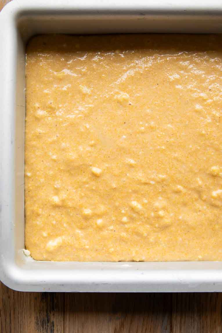 Cornbread batter poured into a baking pan.