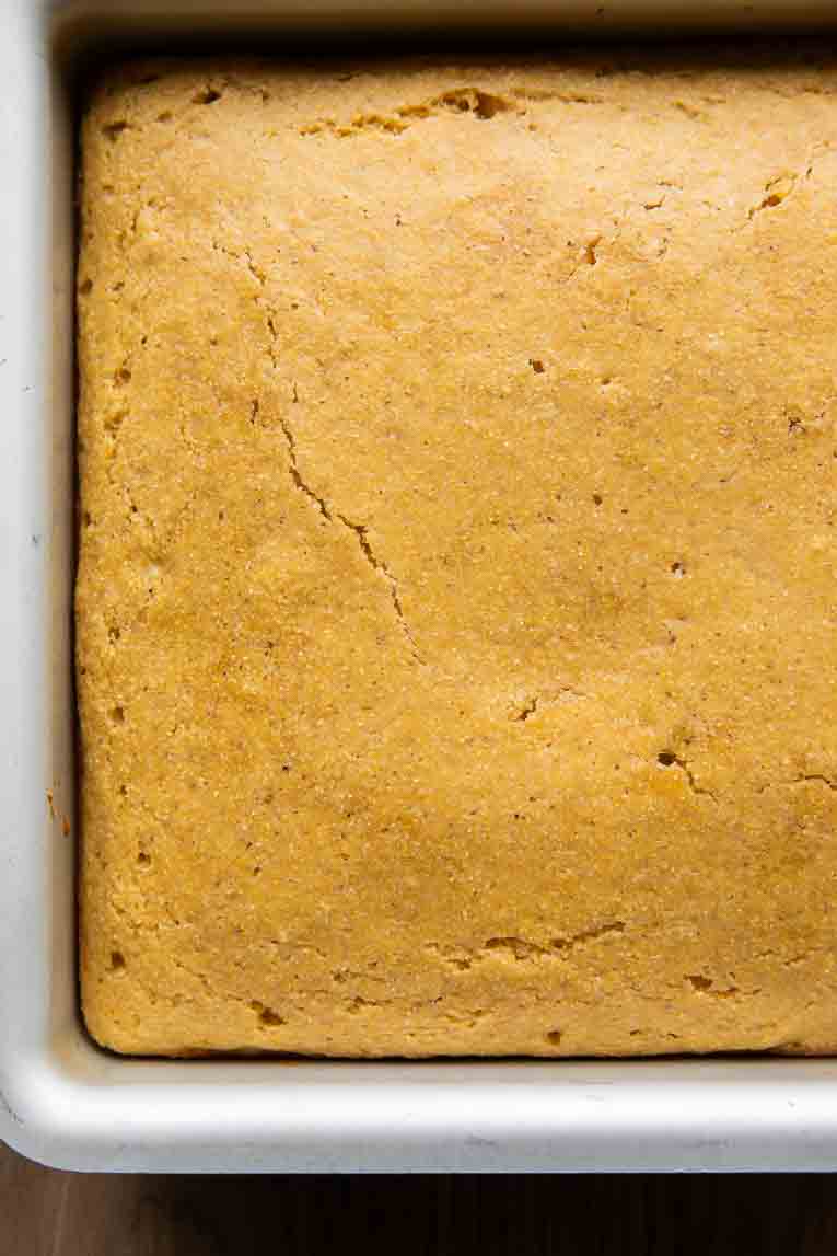 Square baking pan with freshly baked cornbread.