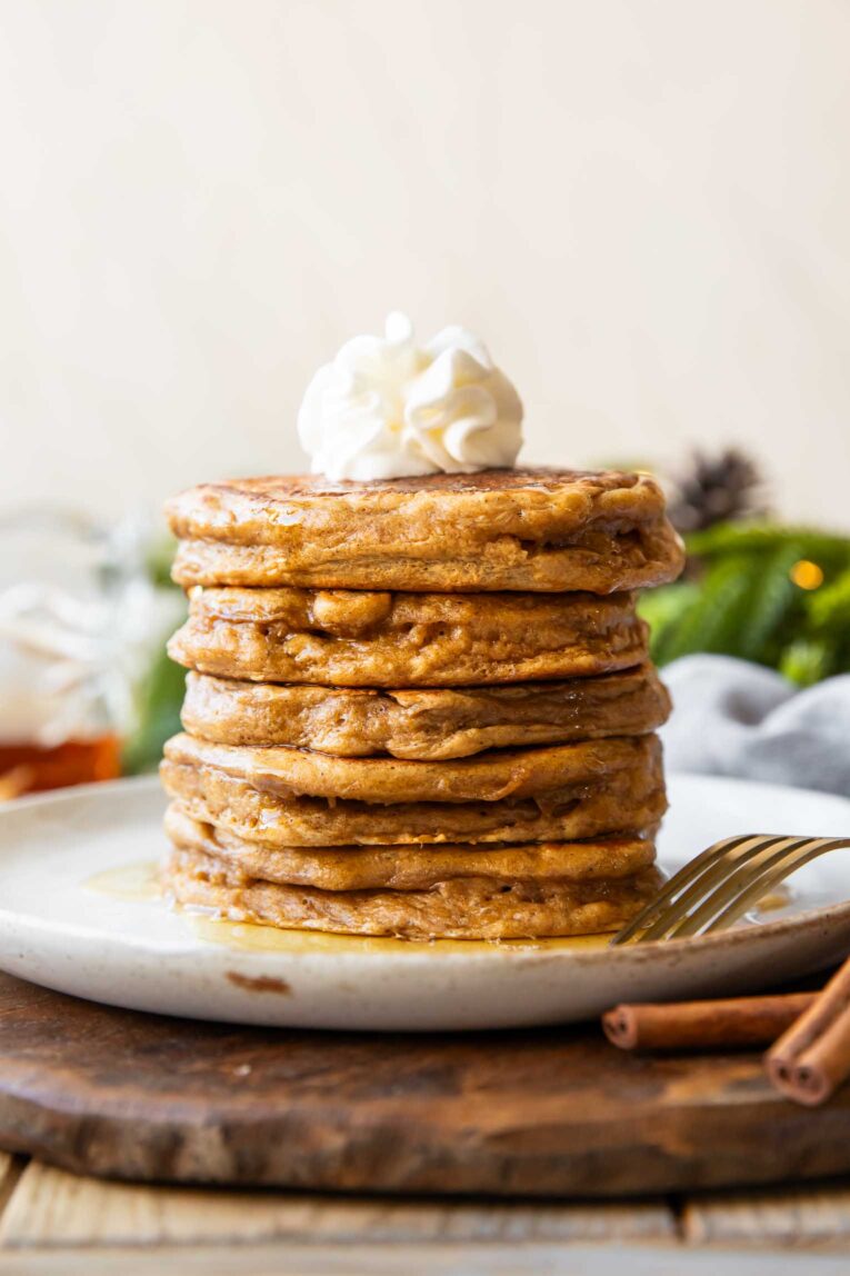 Gingerbread Protein Pancakes recipe stacked on a plate.