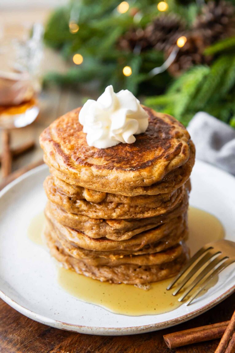Angled photo of Gingerbread Pancakes stacked on a plate.