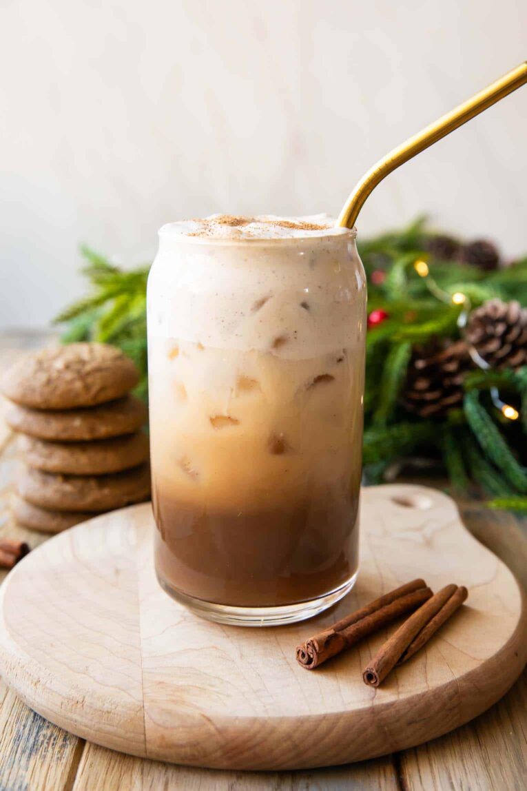 Angled photo of Iced Gingerbread Oatmilk Chai latte.