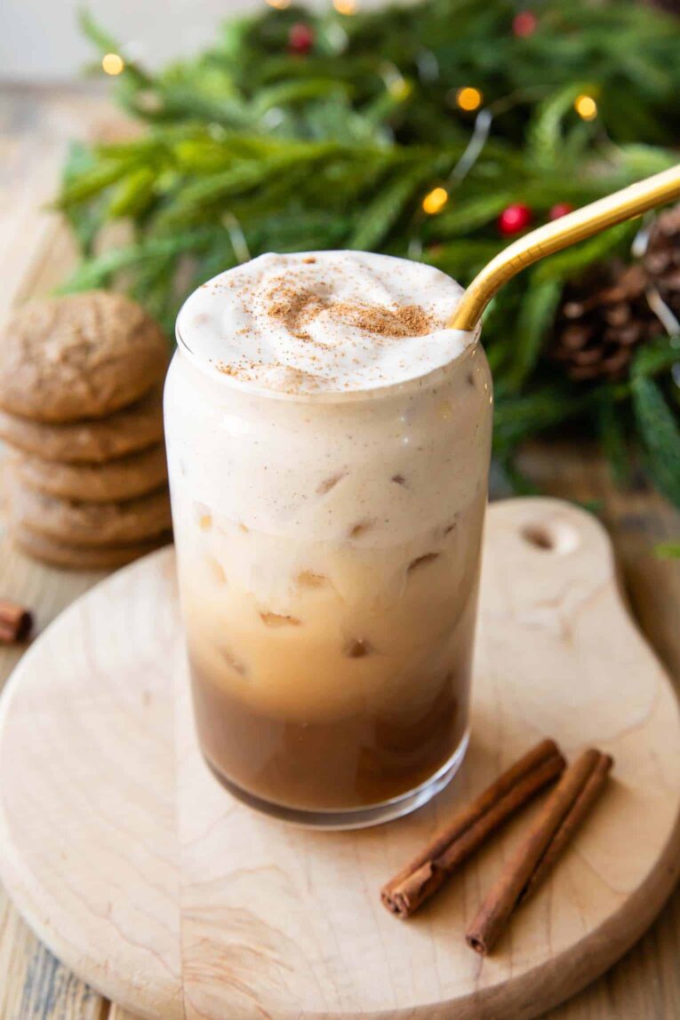 Iced chai oat milk latte in a glass with gingerbread cold foam.