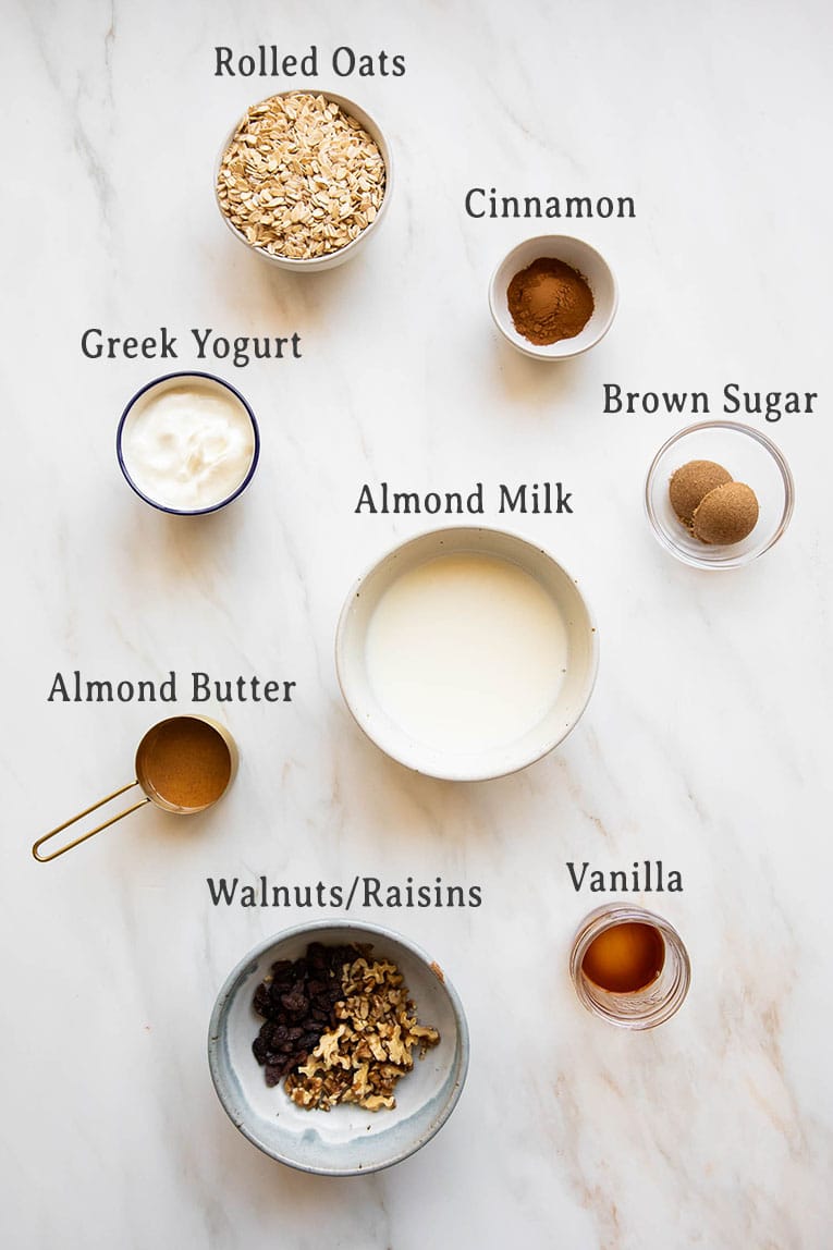 Ingredients for Oatmeal Cookie Overnight Oats recipe on a marble countertop.