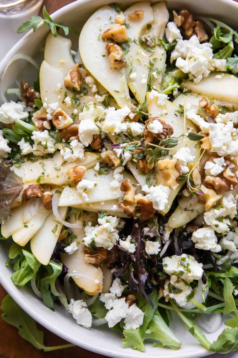 Close up of Pear & Goat Cheese Salad recipe in a bowl.