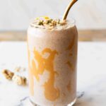 Banana cashew smoothie in a glass with chia seeds.