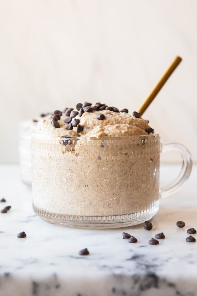 Across photo of Cookie Dough Overnight Oats in a glass mug.