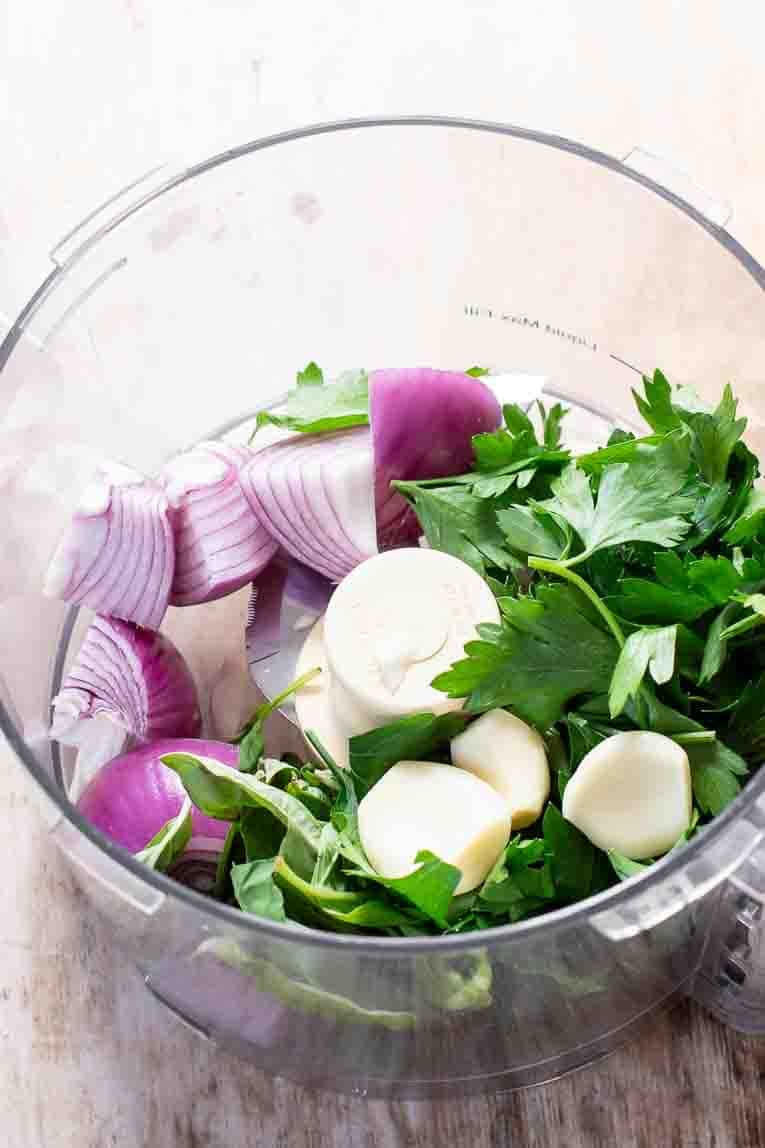 Onions garlic and herbs in a food processor.