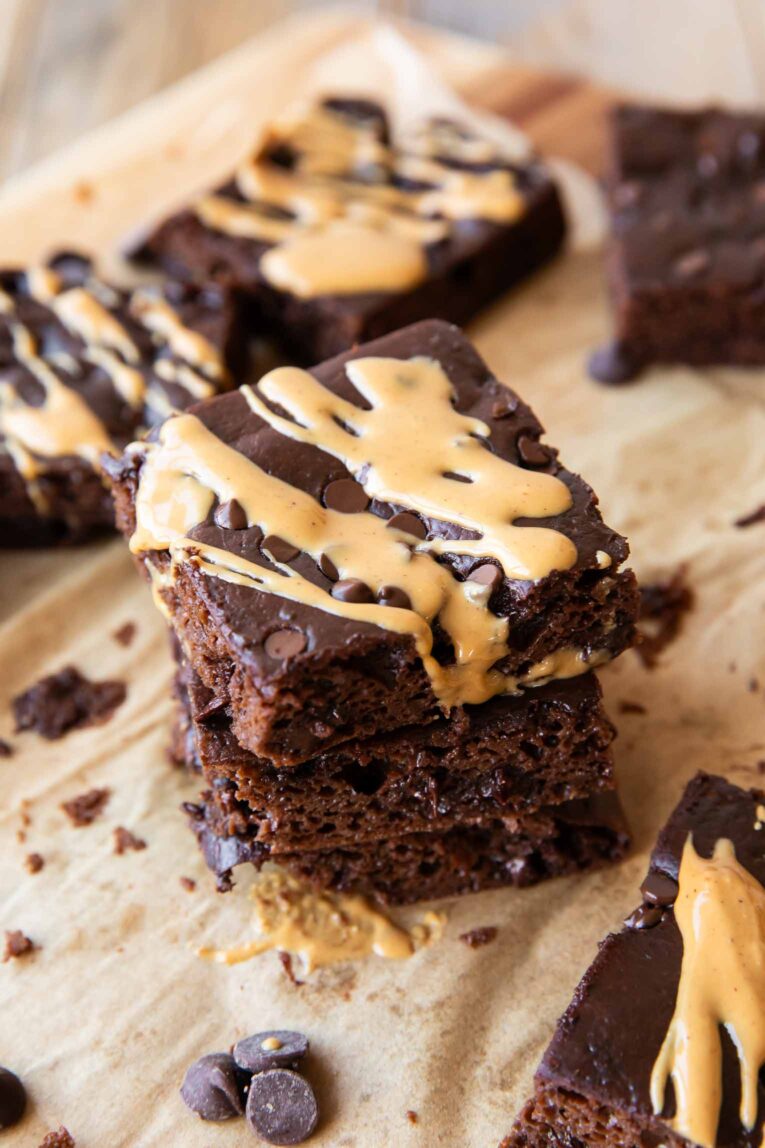 Angled photo of Cottage Cheese Brownies with peanut butter drizzle.