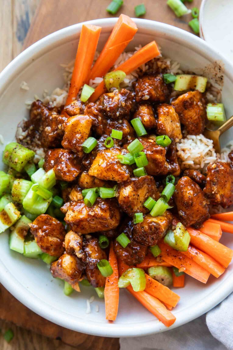 Buffalo chicken in a bowl with crunchy veggies.